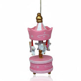 Hediye Kutusu pink wooden carousel ornament with white horses and gold accents, perfect for nursery decor or gift.