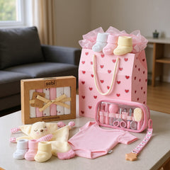 Hediye Kutusu pink heart gift bag with baby socks, bodysuit, washcloths, and grooming kit.